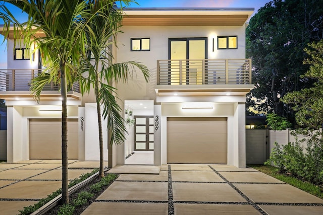 contemporary house featuring a balcony and a garage