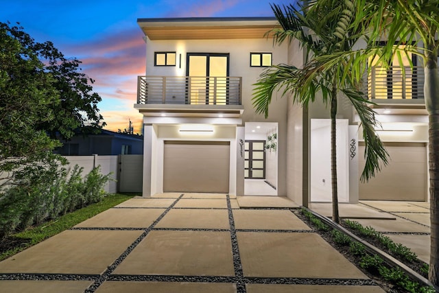 view of front of house featuring a balcony and a garage