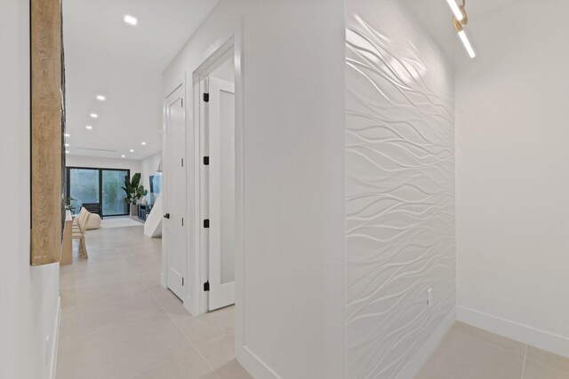 hallway featuring light tile patterned floors