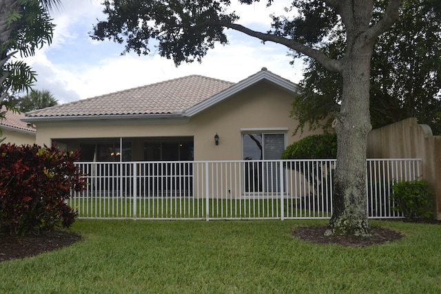 rear view of house with a yard