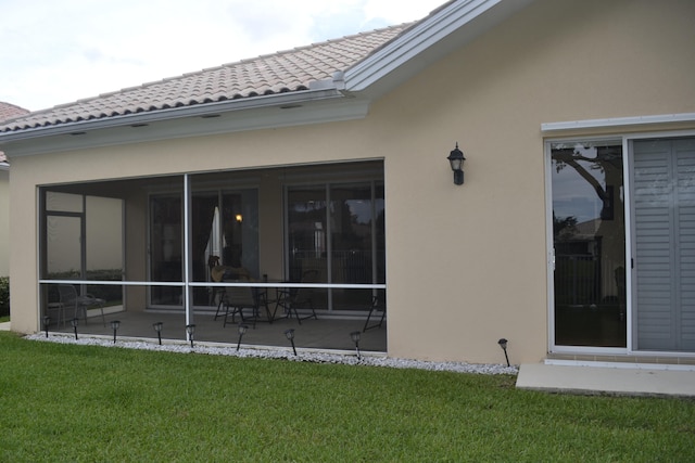 rear view of property featuring a yard