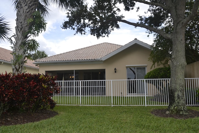 rear view of property with a yard