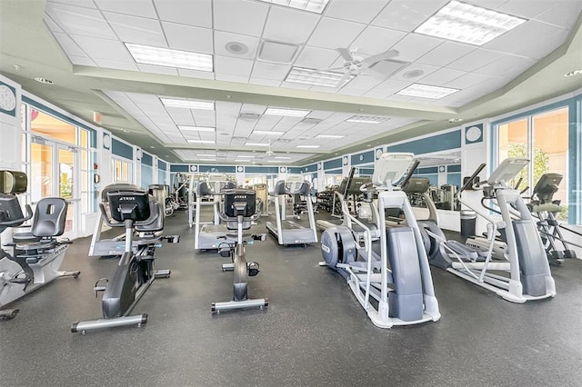 gym with ceiling fan and a paneled ceiling