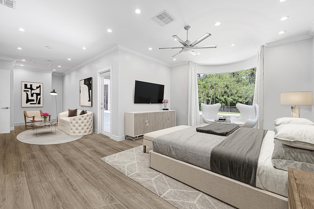 bedroom with light hardwood / wood-style floors, ornamental molding, and ceiling fan