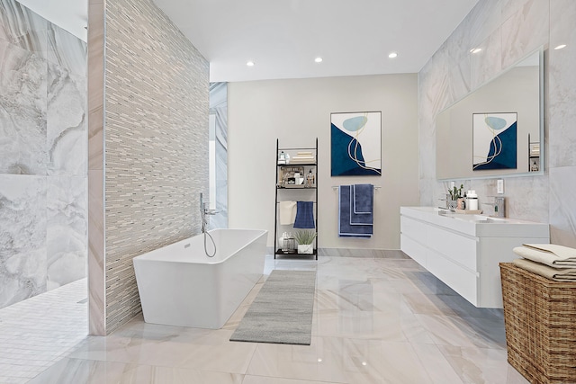 bathroom with vanity, tile walls, and plus walk in shower