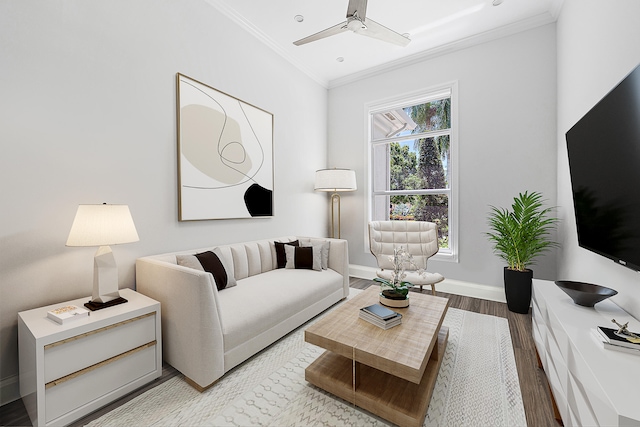 living room featuring ornamental molding, hardwood / wood-style flooring, and ceiling fan