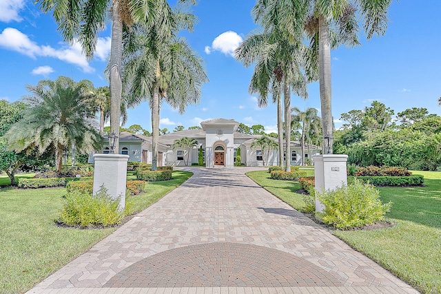 mediterranean / spanish-style house with a front lawn