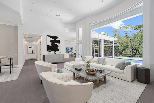 living room with tile patterned flooring and a high ceiling