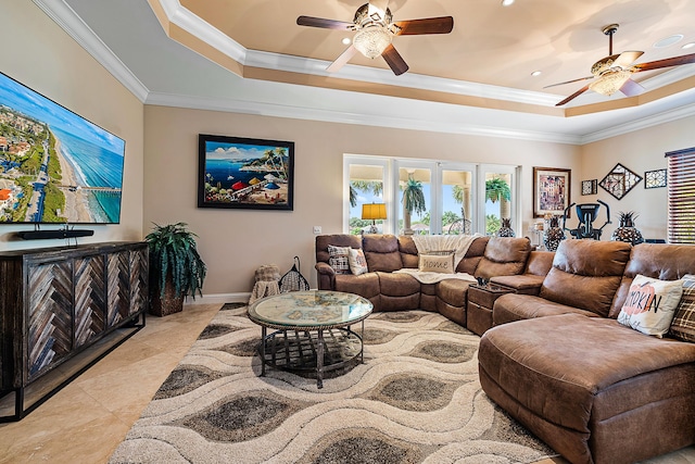 living area featuring ceiling fan, ornamental molding, and a raised ceiling