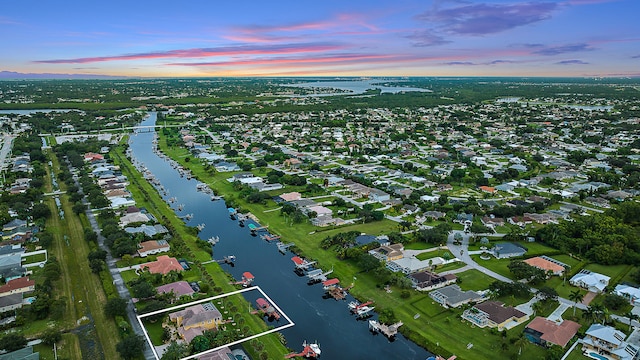 aerial view at dusk with a water view