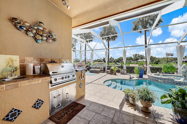 exterior space featuring area for grilling, glass enclosure, a patio area, a sink, and exterior kitchen