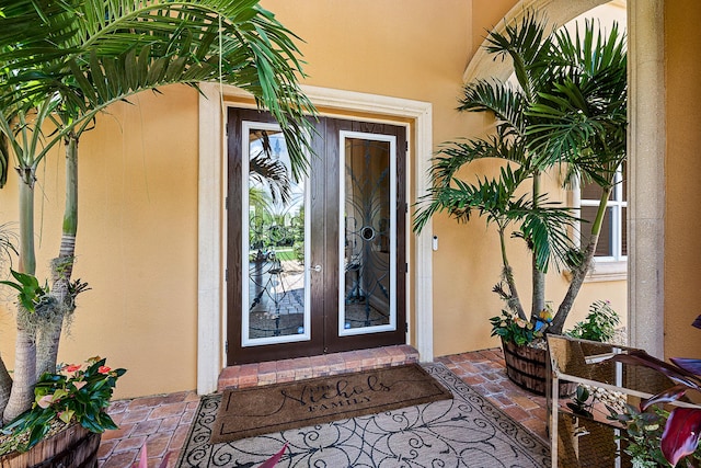 property entrance with french doors and stucco siding