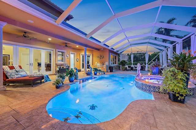 view of pool with a pool with connected hot tub, an outdoor hangout area, a ceiling fan, a patio area, and a lanai