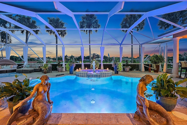 view of swimming pool with a lanai, a patio area, and a pool with connected hot tub