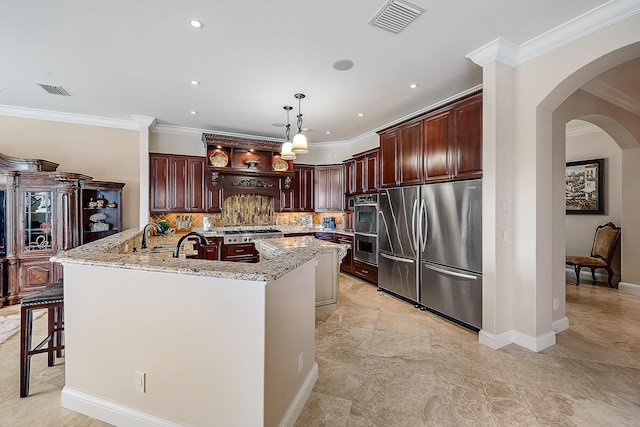 kitchen with visible vents, appliances with stainless steel finishes, light stone counters, and pendant lighting