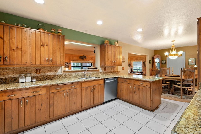 kitchen with an inviting chandelier, sink, hanging light fixtures, kitchen peninsula, and stainless steel dishwasher