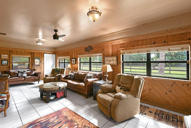 12390 Sandy Run, Jupiter, FL 33478 - living area with wood walls, light tile patterned flooring, and ceiling fan