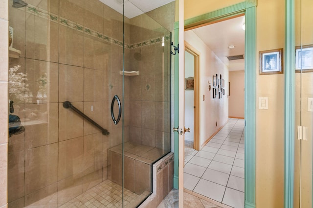 bathroom with walk in shower and tile patterned floors