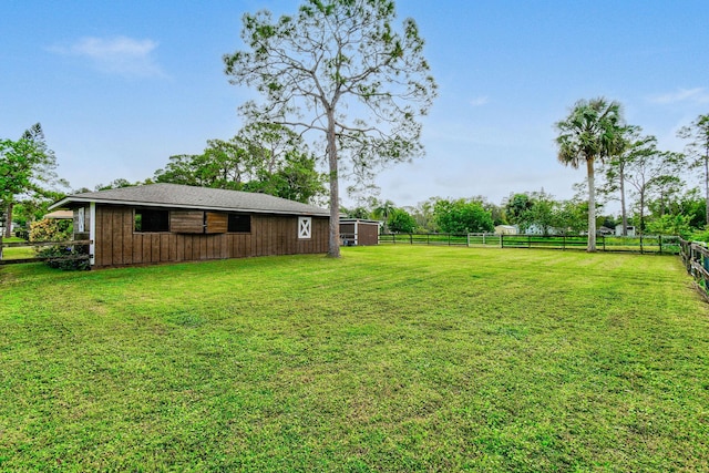 view of yard with a rural view and an outdoor structure