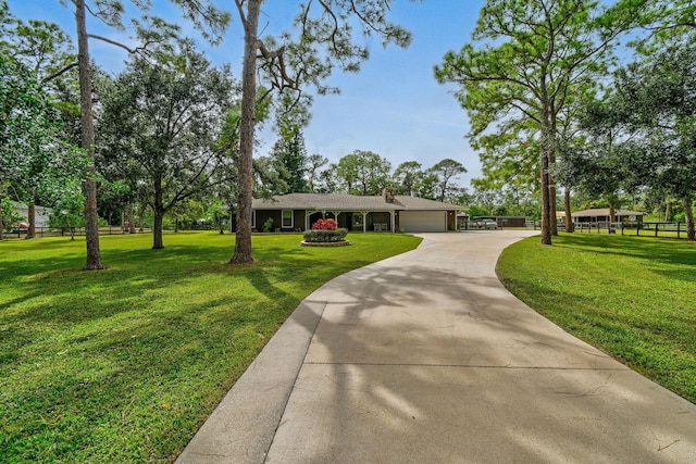 ranch-style house with a front yard and a garage