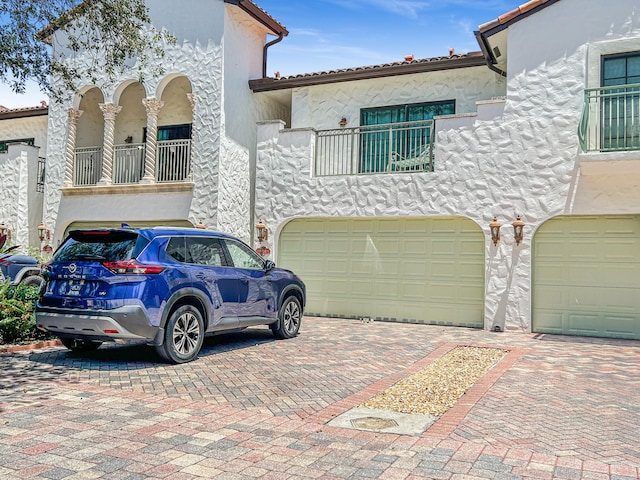 mediterranean / spanish house with a balcony and a garage