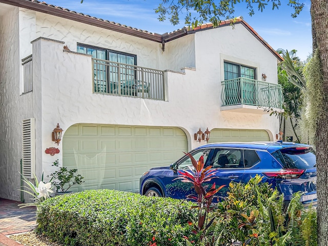 view of front of house with a balcony and a garage