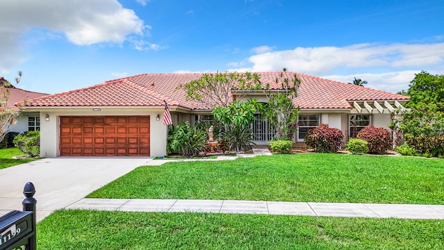 mediterranean / spanish home with a front lawn and a garage