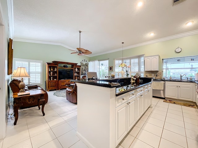 kitchen with stainless steel dishwasher, ornamental molding, a center island, ceiling fan, and light tile patterned flooring