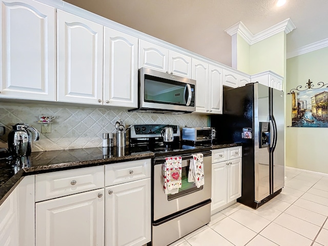 kitchen with backsplash, dark stone countertops, stainless steel appliances, crown molding, and white cabinets