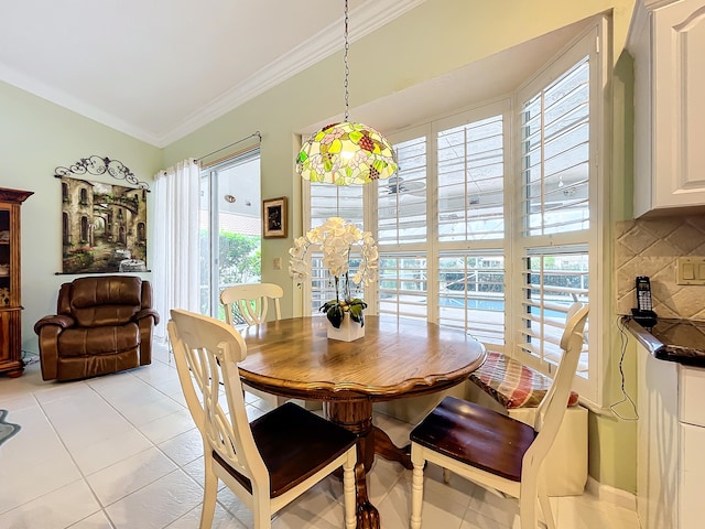 dining area featuring light tile patterned floors and crown molding