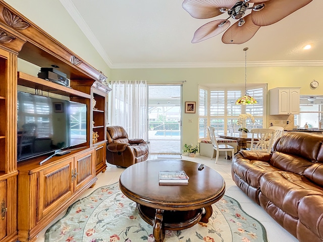 living room with ceiling fan, ornamental molding, vaulted ceiling, and light tile patterned floors