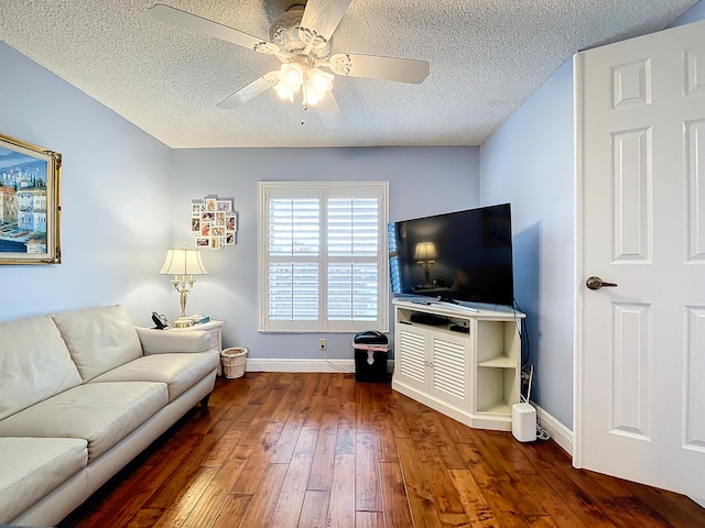 living room featuring a textured ceiling, ceiling fan, and hardwood / wood-style flooring