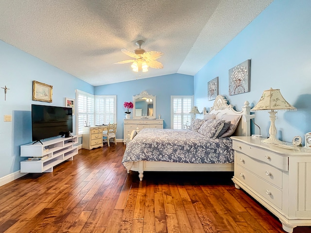 bedroom with ceiling fan, multiple windows, wood-type flooring, and lofted ceiling