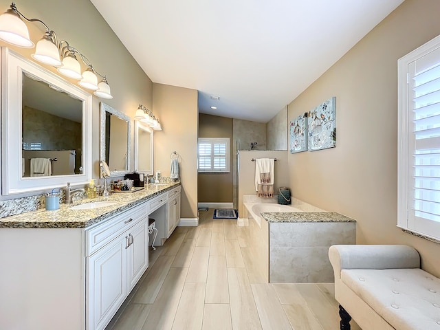 bathroom with plus walk in shower, vanity, and lofted ceiling