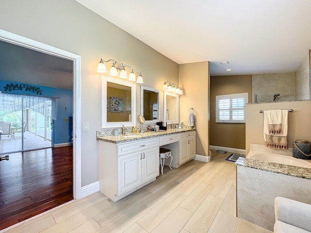 bathroom with hardwood / wood-style floors, vanity, and lofted ceiling