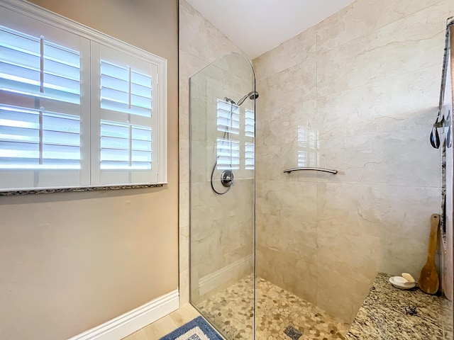 bathroom with a tile shower