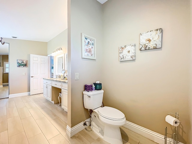 bathroom featuring toilet and vanity