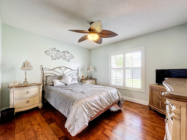 bedroom featuring a textured ceiling, ceiling fan, and dark hardwood / wood-style floors