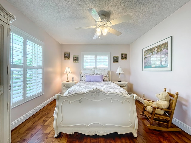 bedroom featuring hardwood / wood-style floors, ceiling fan, and a textured ceiling