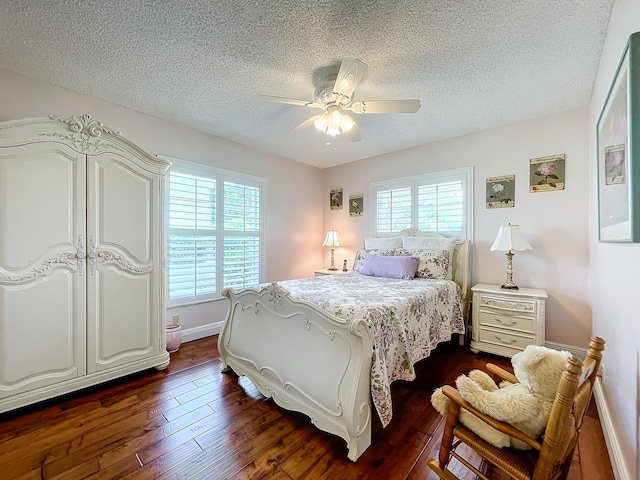 bedroom featuring ceiling fan, a textured ceiling, and dark hardwood / wood-style flooring