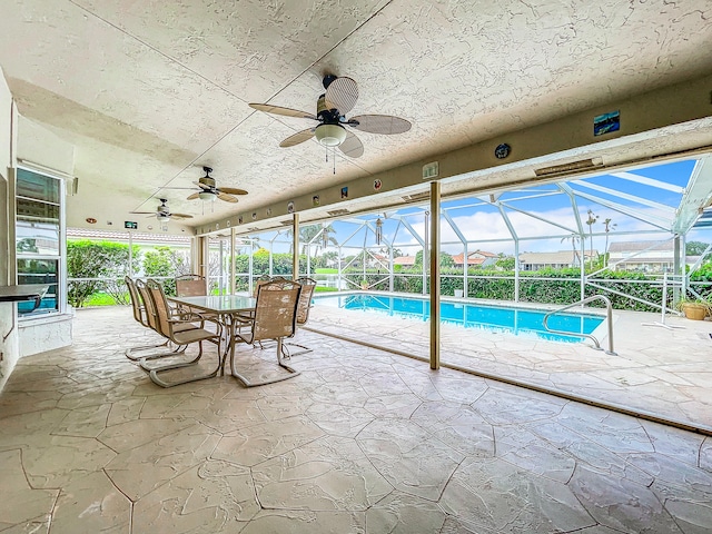 view of pool with ceiling fan, a patio, and a lanai