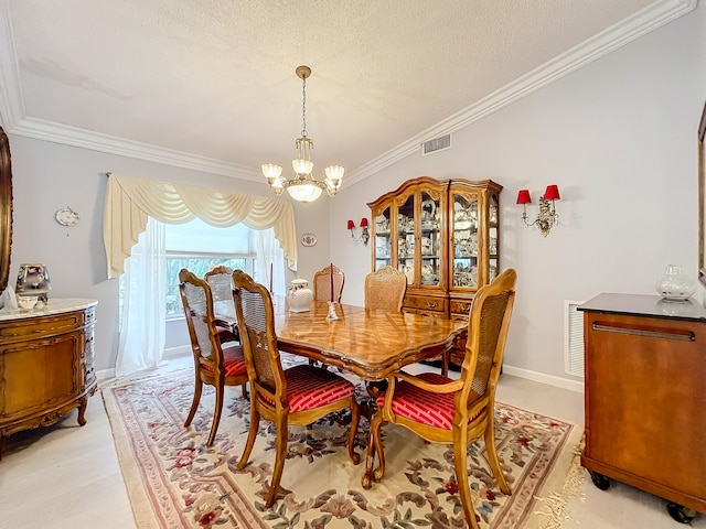 dining area featuring a textured ceiling, a chandelier, and ornamental molding