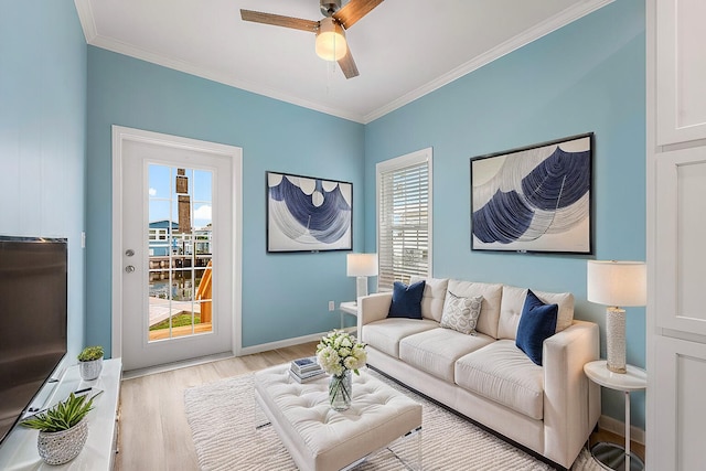 living room featuring ornamental molding, ceiling fan, and light hardwood / wood-style floors