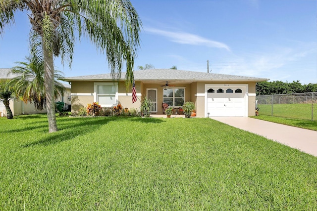 ranch-style home featuring ceiling fan, a front lawn, and a garage