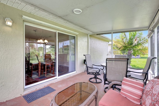 sunroom featuring a notable chandelier