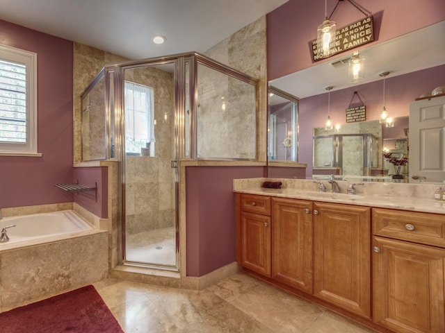 bathroom with vanity and independent shower and bath