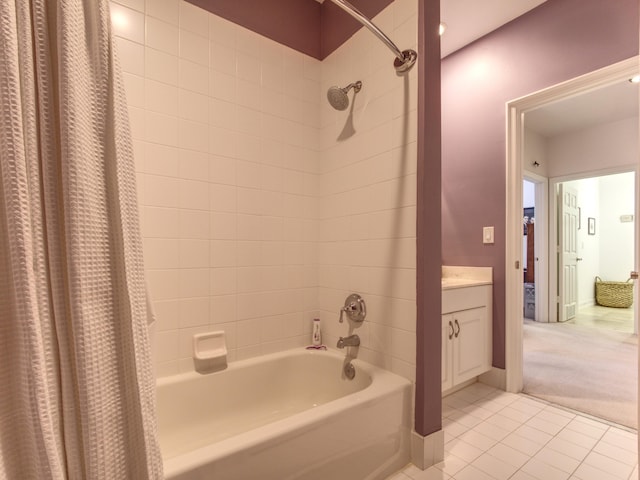 bathroom with tile patterned flooring, vanity, and shower / tub combo