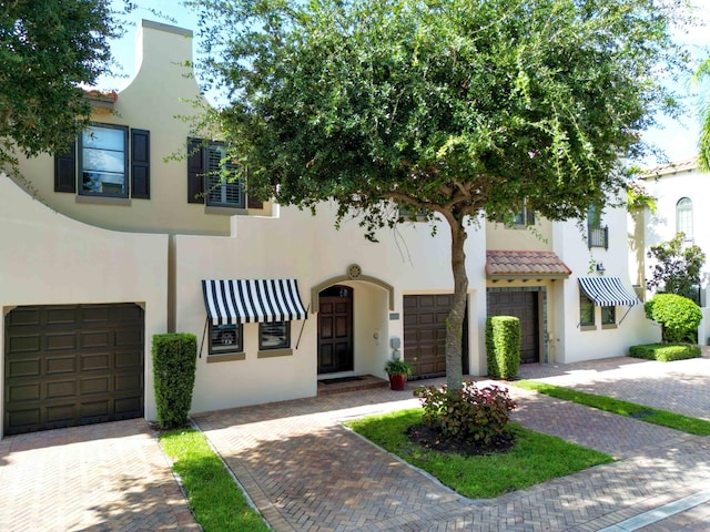 mediterranean / spanish home featuring a garage