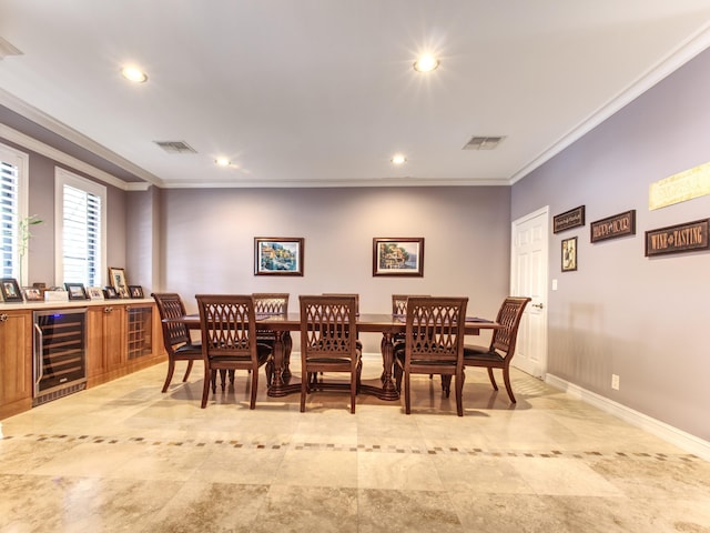 dining area featuring ornamental molding and beverage cooler