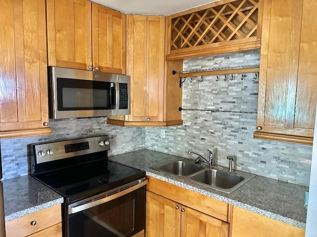 kitchen with tasteful backsplash, sink, and stainless steel appliances